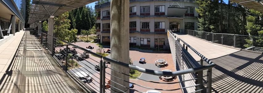 Image of the courtyard from the balcony. The balcony has chairs and half sun cover.